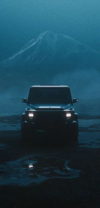 A solitary car driving on a foggy road with a mountain in the backdrop.