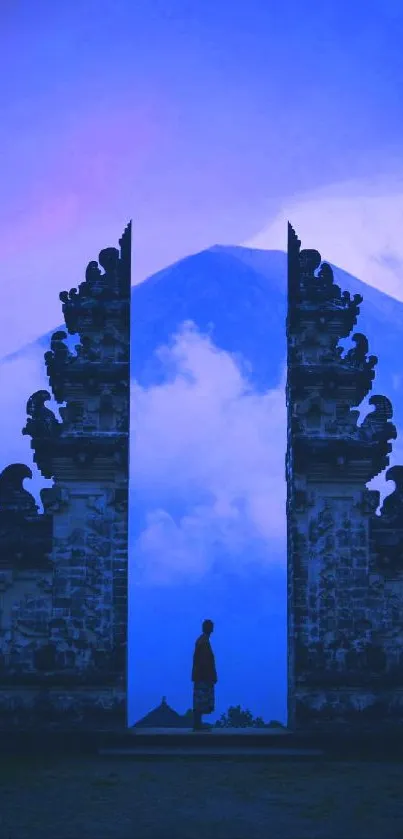 Blue mystical wallpaper with mountain gate and silhouette.