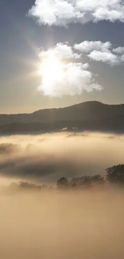 Misty mountain landscape with sun and clouds at dawn.