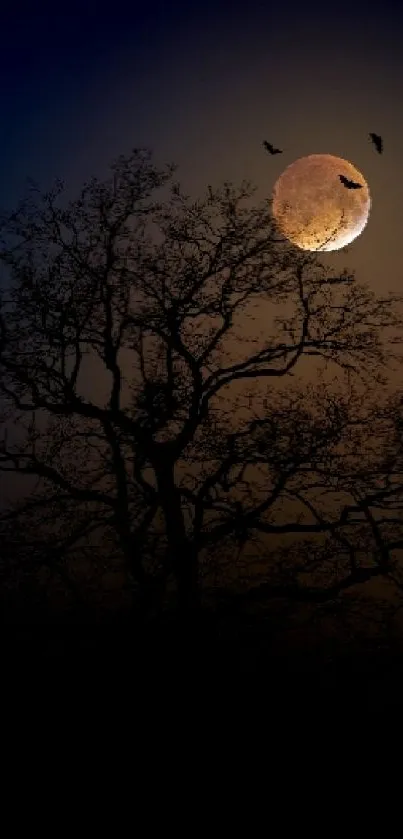 Silhouetted tree with a glowing moon and bats at night.