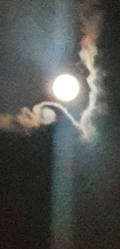 Full moon in a mystical night sky with wispy clouds surrounding it.