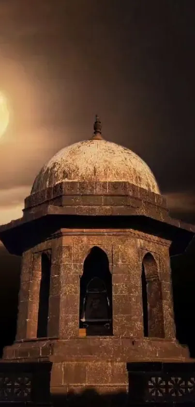 Gothic stone tower under a full moon in a dark night sky.