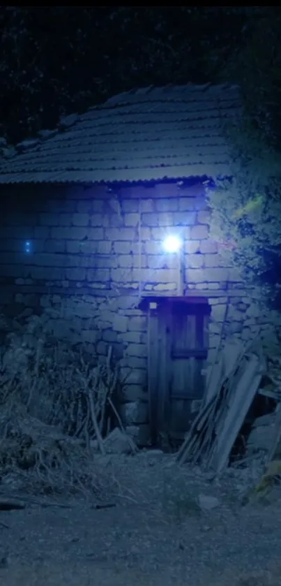 Rustic stone cottage illuminated by a blue night light.