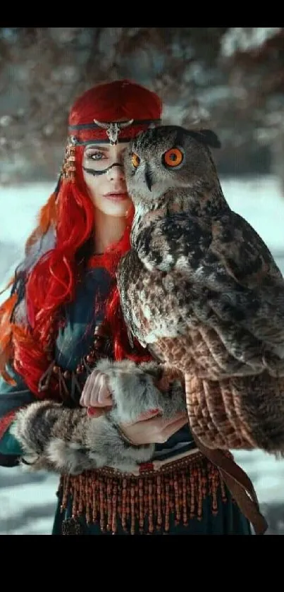 Woman with red hair holding an owl in a snowy forest background.