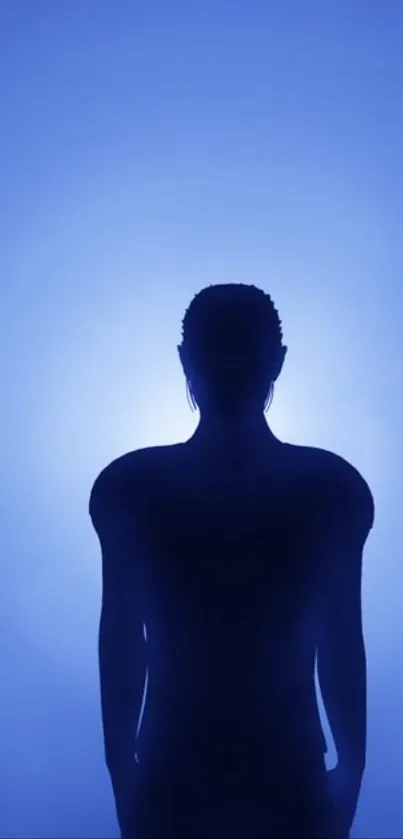 Silhouette of person with blue ethereal background, creating a mystical ambiance.