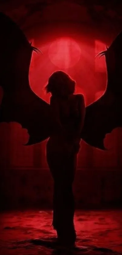 Silhouette stands with wings under a radiant red glow, creating a dramatic scene.