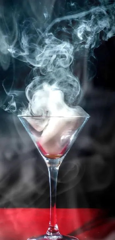 Smoke swirls in a martini glass on a red surface.