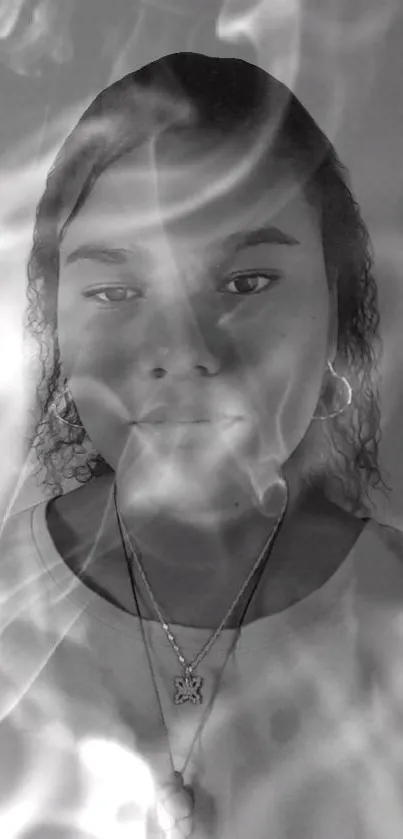 Monochrome smoke art with a mystical portrait in grayscale tones.