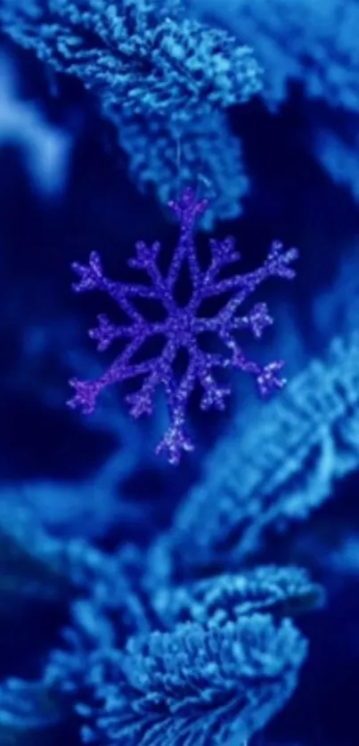 Purple snowflake amidst blue frosted foliage on mobile wallpaper.