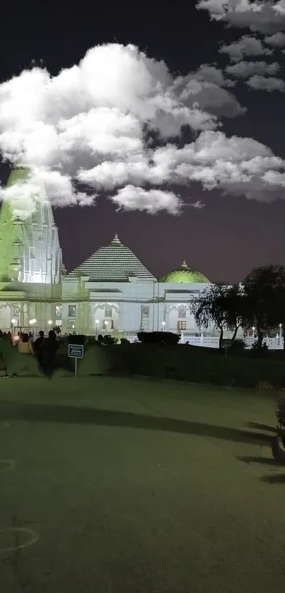 Night view of beautifully lit temple under clouds with a scenic ambiance.