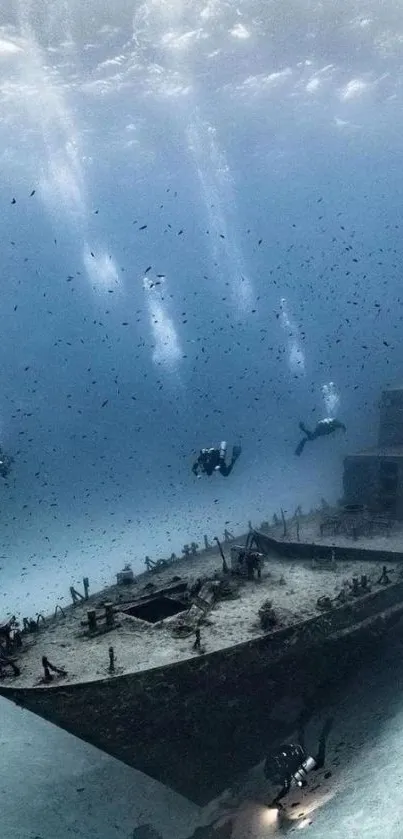 Dramatic underwater shipwreck with divers in a serene blue ocean landscape.