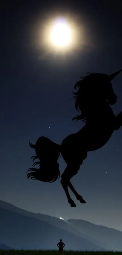 Silhouette of a unicorn against a moonlit night sky over mountains.