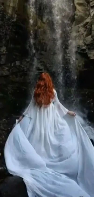 A mystical lady in white stands before a waterfall.