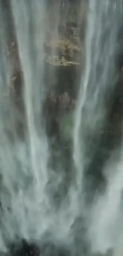 Majestic vertical waterfall cascading down rocky cliff.