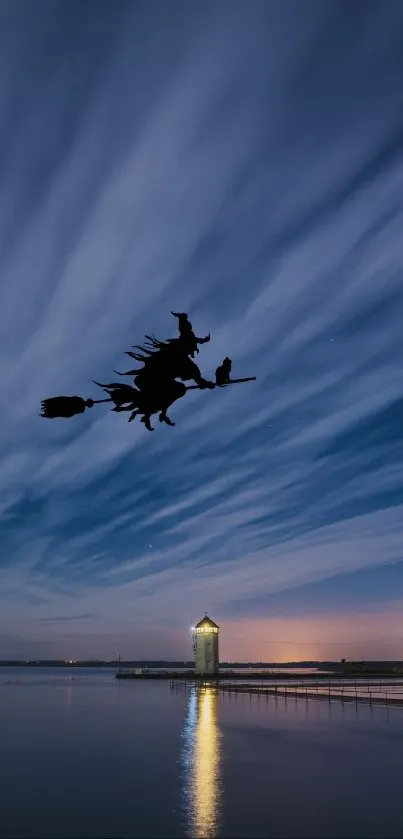 Silhouette of a witch flying over a nocturnal sky reflected in tranquil waters.