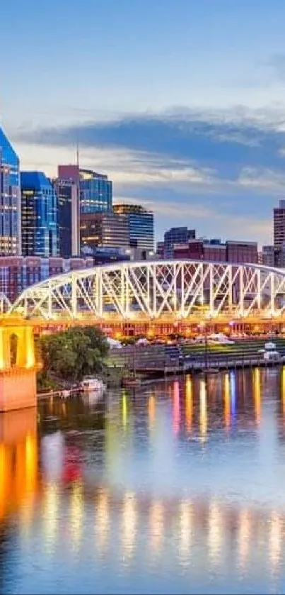 Nashville city skyline at sunset with reflections on river.