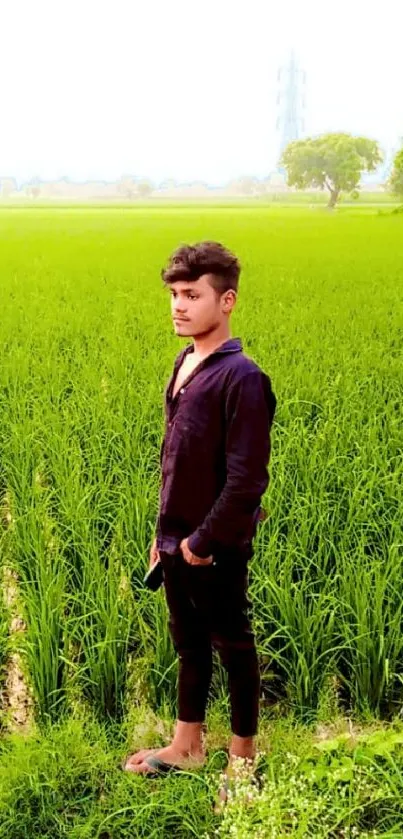 Person standing in lush green field with serene landscape background.