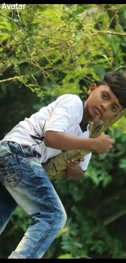 Child climbing a tree in a lush green setting wallpaper.