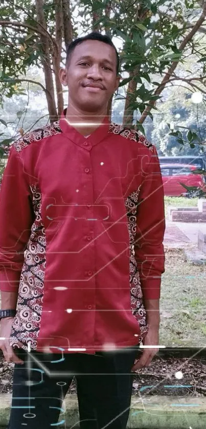 Outdoor portrait of a person in a red shirt with lush greenery.