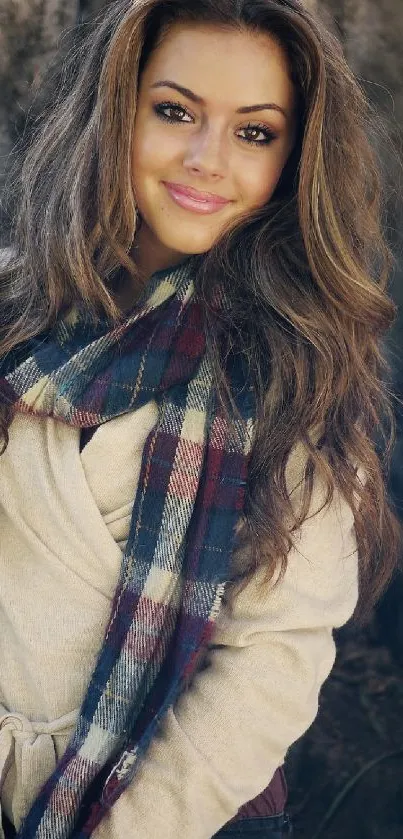 Portrait of a woman in nature with a cozy scarf by a tree.