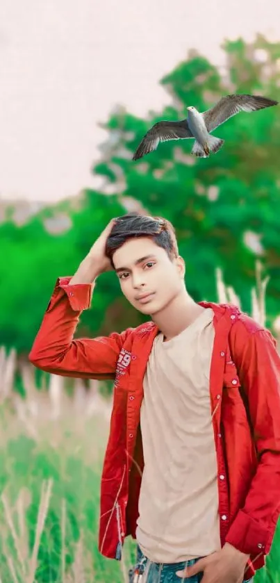 Young man poses in nature with bird overhead.