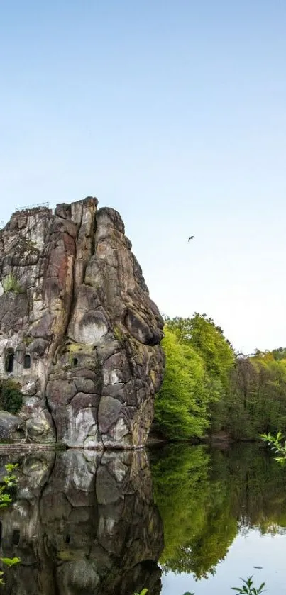 Nature rock reflection wallpaper with clear sky and greenery.