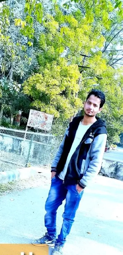 Man standing on a path with greenery around.