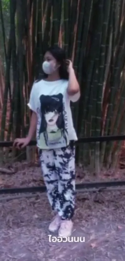 Person in graphic tee by bamboo forest.