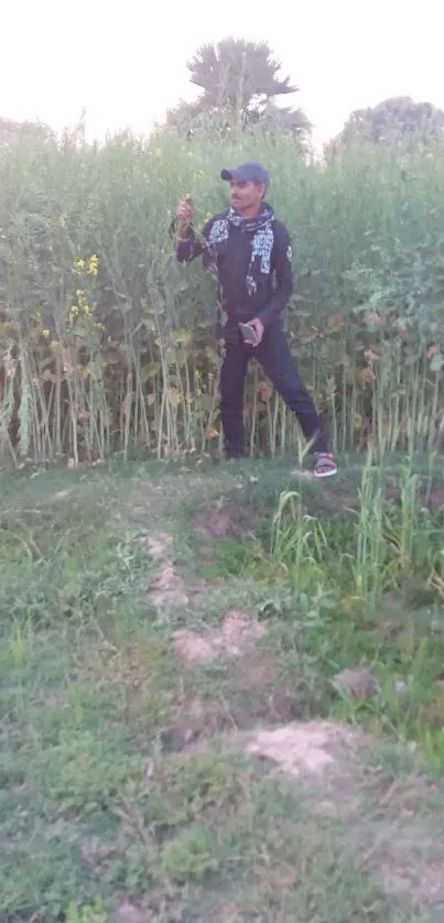 Person walking in a lush green field.