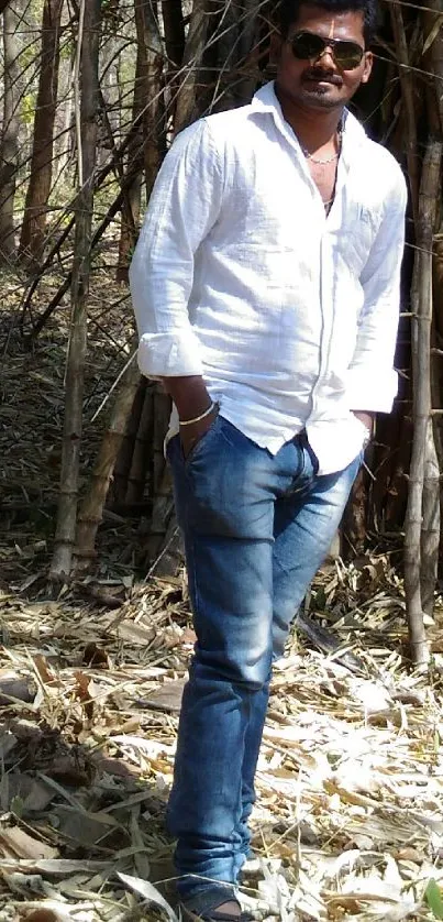 Person standing in serene bamboo forest setting.