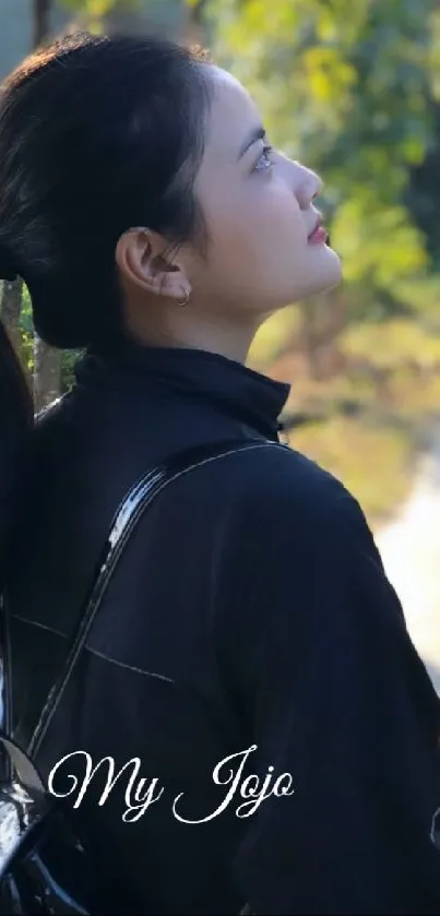 Woman enjoys serene nature on a sunlit path.