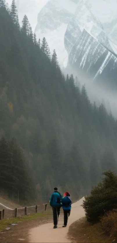 Two people walking on a misty mountain path with trees and fog in the background.