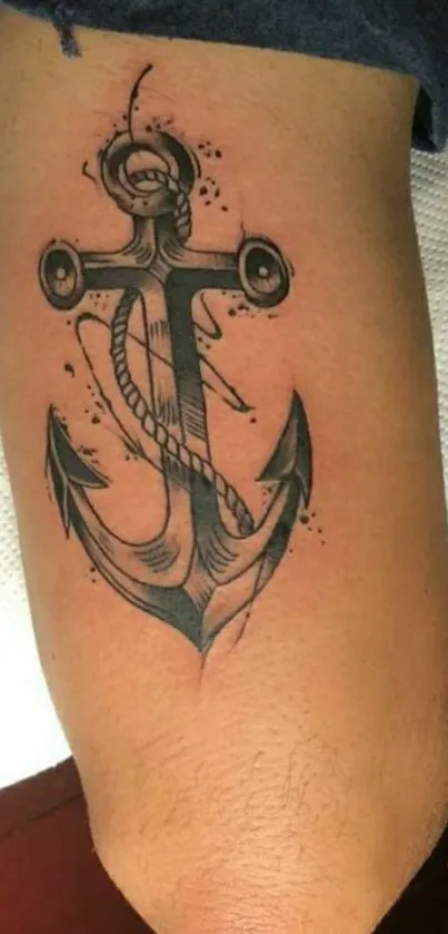 Detailed anchor tattoo on arm, nautical design.