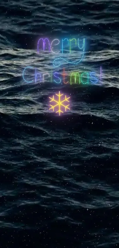 Neon 'Merry Christmas' over ocean waves with starry background.