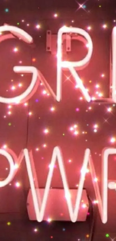 Neon 'Girl Power' sign with sparkles on a pink background.