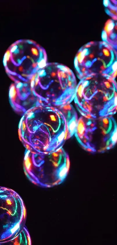 Colorful neon glass orbs on black background.