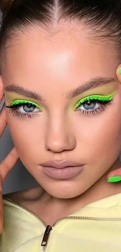 Closeup of a model with neon makeup and nails.