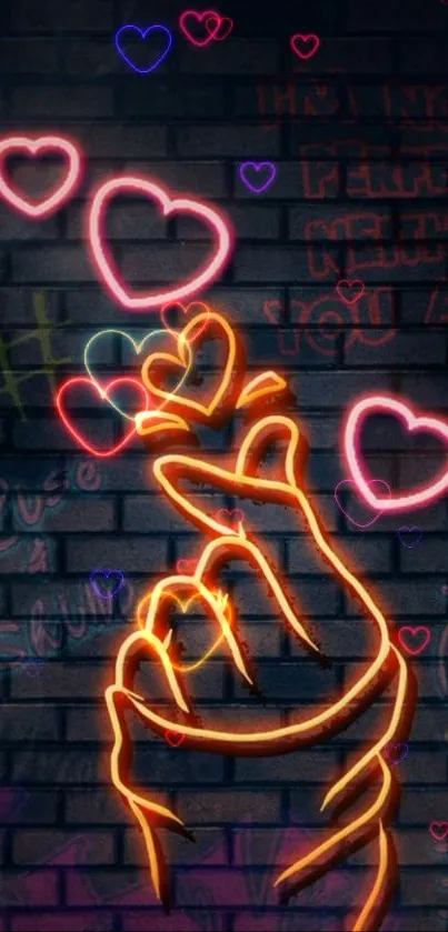 Neon heart gesture with graffiti background on a dark brick wall.