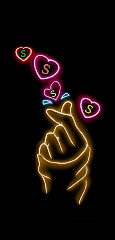 Neon hand with colorful hearts on black background.