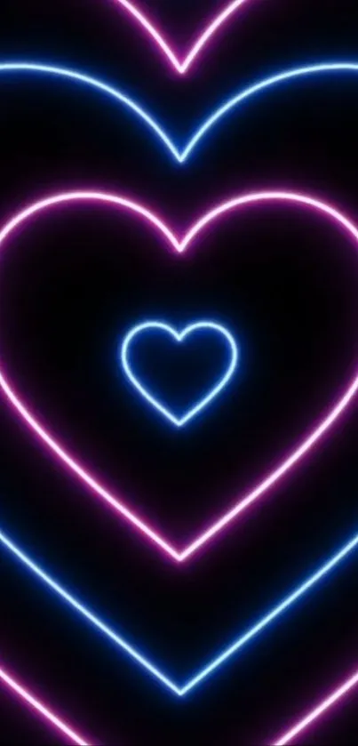 Neon hearts with glowing pink and blue outlines on a black background.