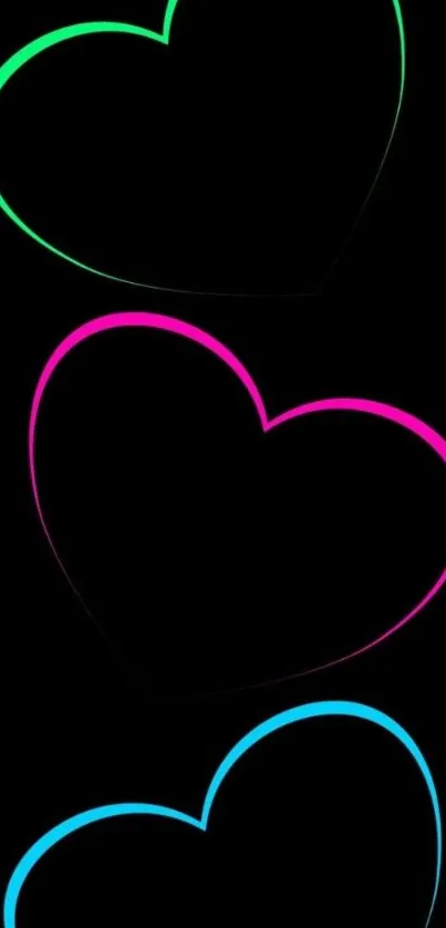 Neon hearts glowing on black background wallpaper.