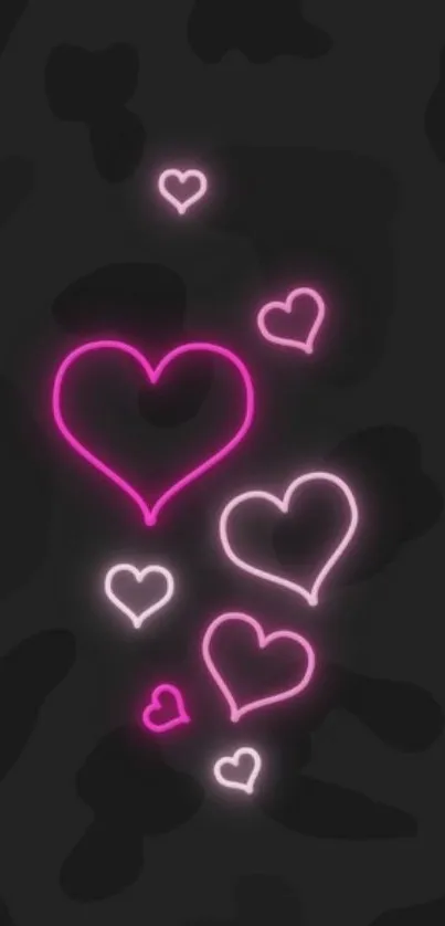 Vibrant neon hearts glowing on a dark background wallpaper.