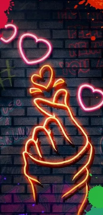 Neon art featuring a love hand gesture with hearts on a colorful graffiti wall.