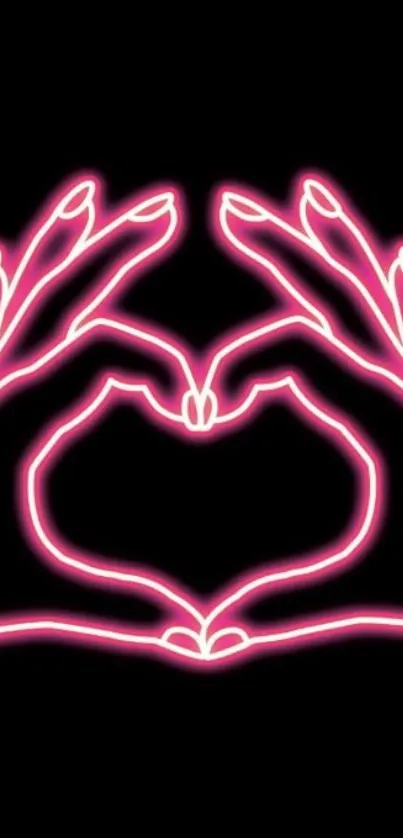 Neon pink hands forming a heart on a black background.