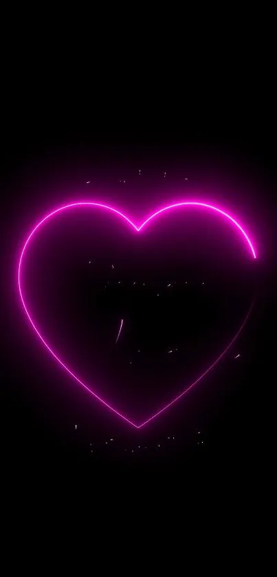 Neon heart glowing on black background wallpaper.