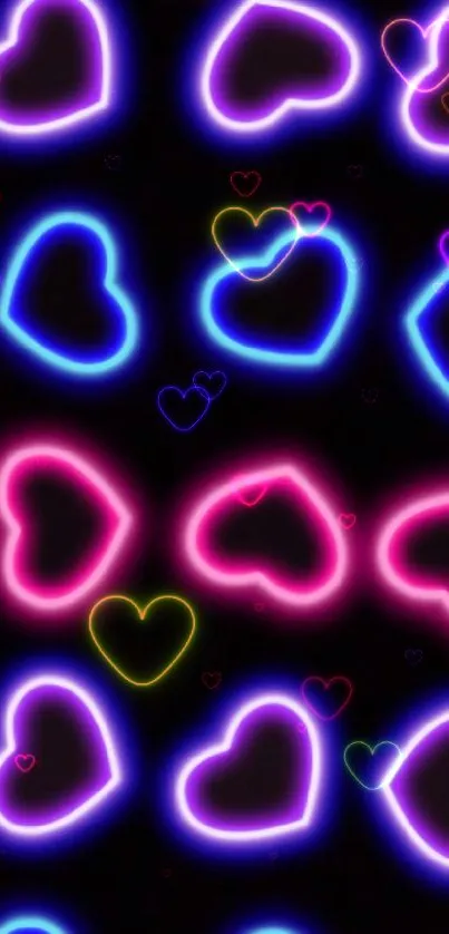 Colorful neon hearts wallpaper with pink and blue glow on a black background.