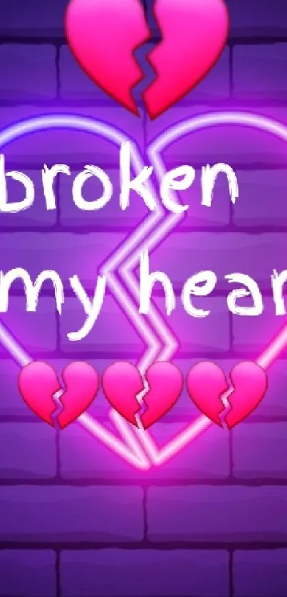 Neon broken heart graffiti on a brick wall.