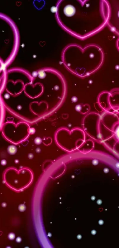 Neon pink hearts on a dark background wallpaper.