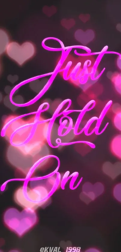 Neon pink 'Just Hold On' quote on dark background wallpaper.