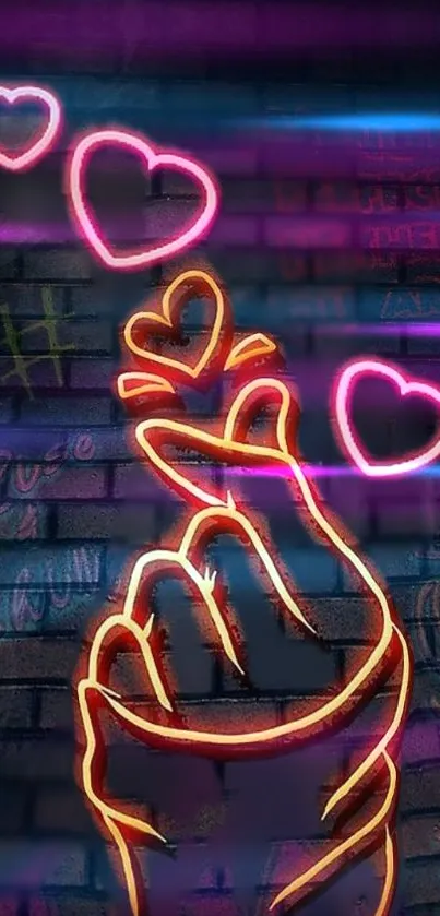 Neon hand gesture with hearts on brick wall.